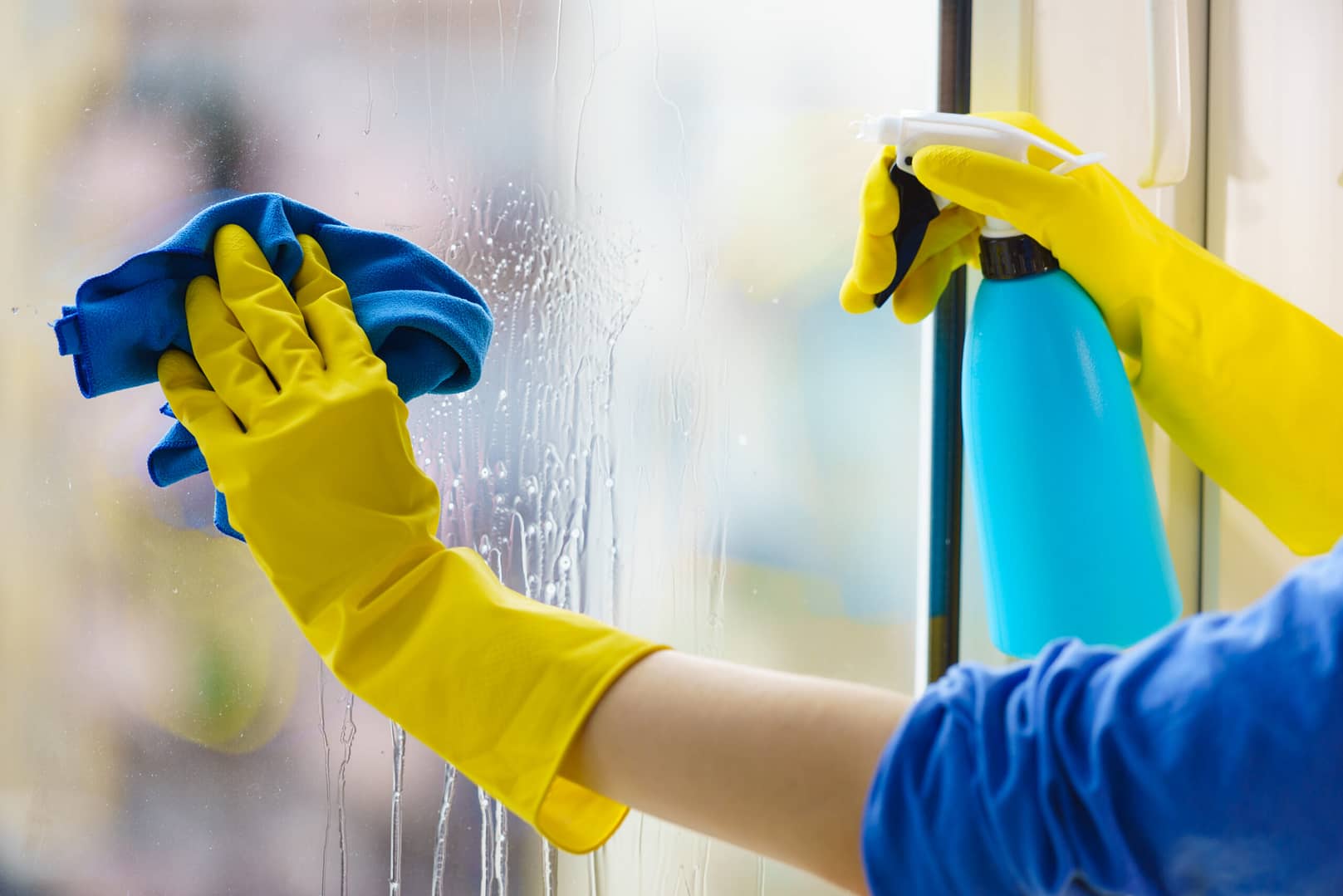 Window cleaner in action, emphasizing the precision in window cleaning marketing.