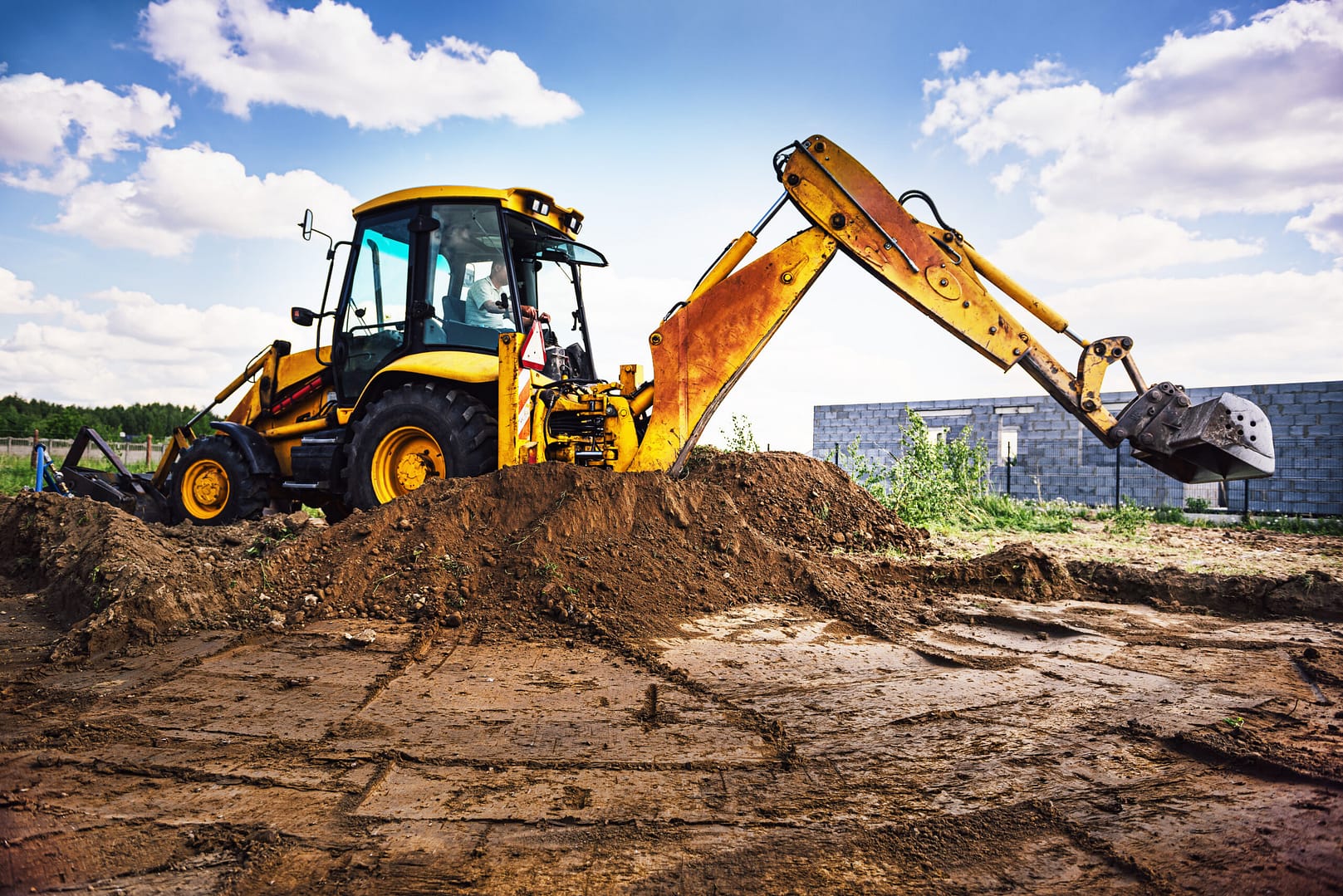 Excavation contractor meticulously regrading a land site, highlighting the precision and expertise promoted through effective marketing.