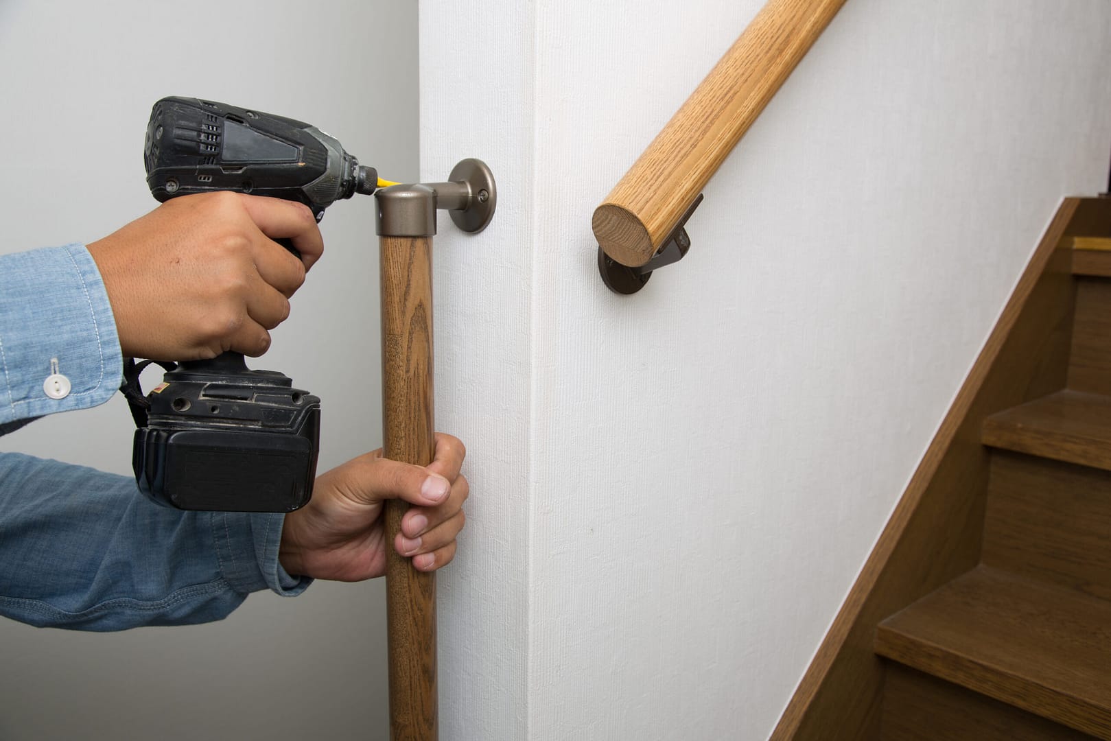 Finishing crew member crafting a perfect railing - paralleling Local Splash's commitment to finely-tuning your General Contractor marketing for optimal online visibility and craftsmanship in digital strategies.