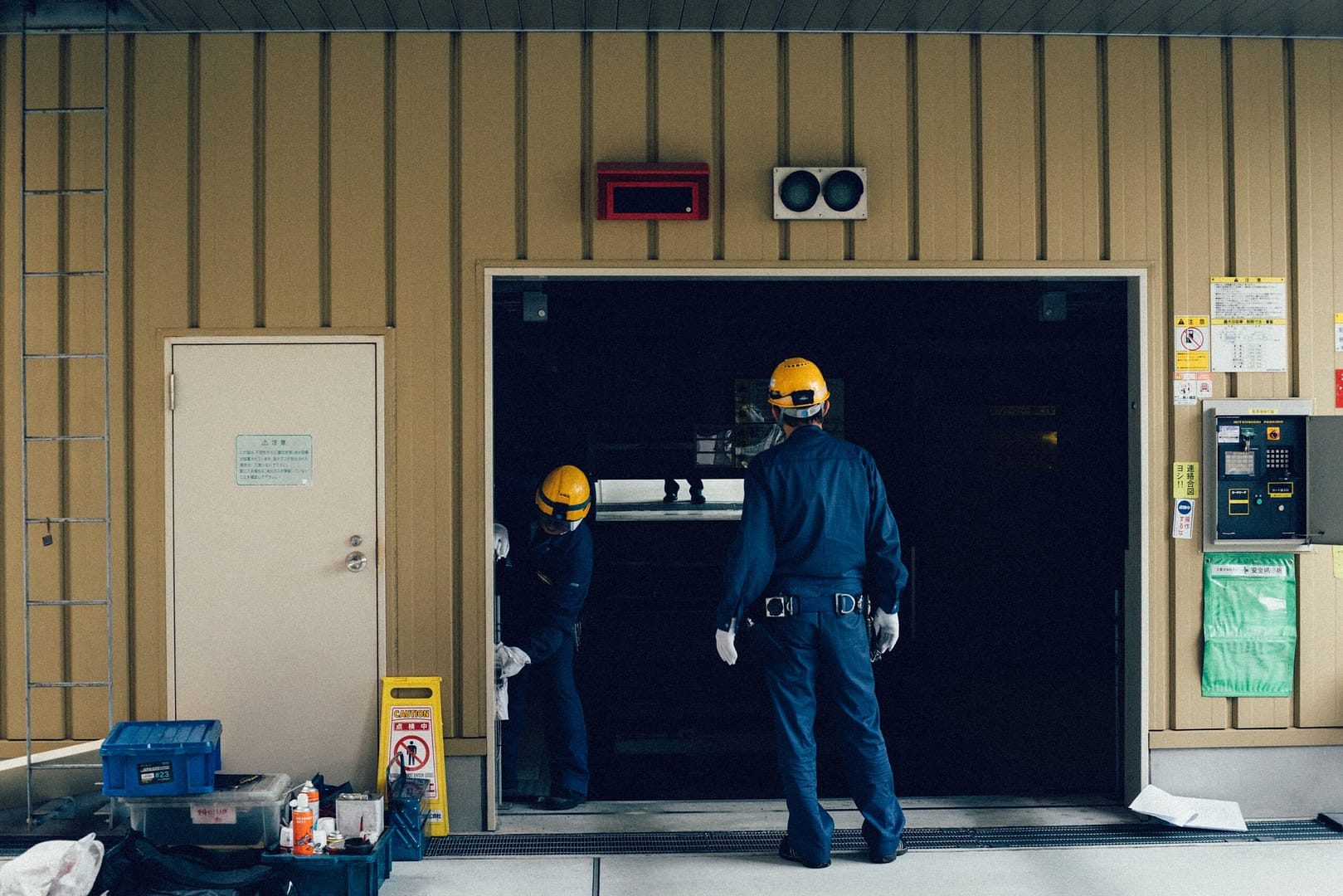 Men in uniform carefully installing a new garage door with precision and teamwork.