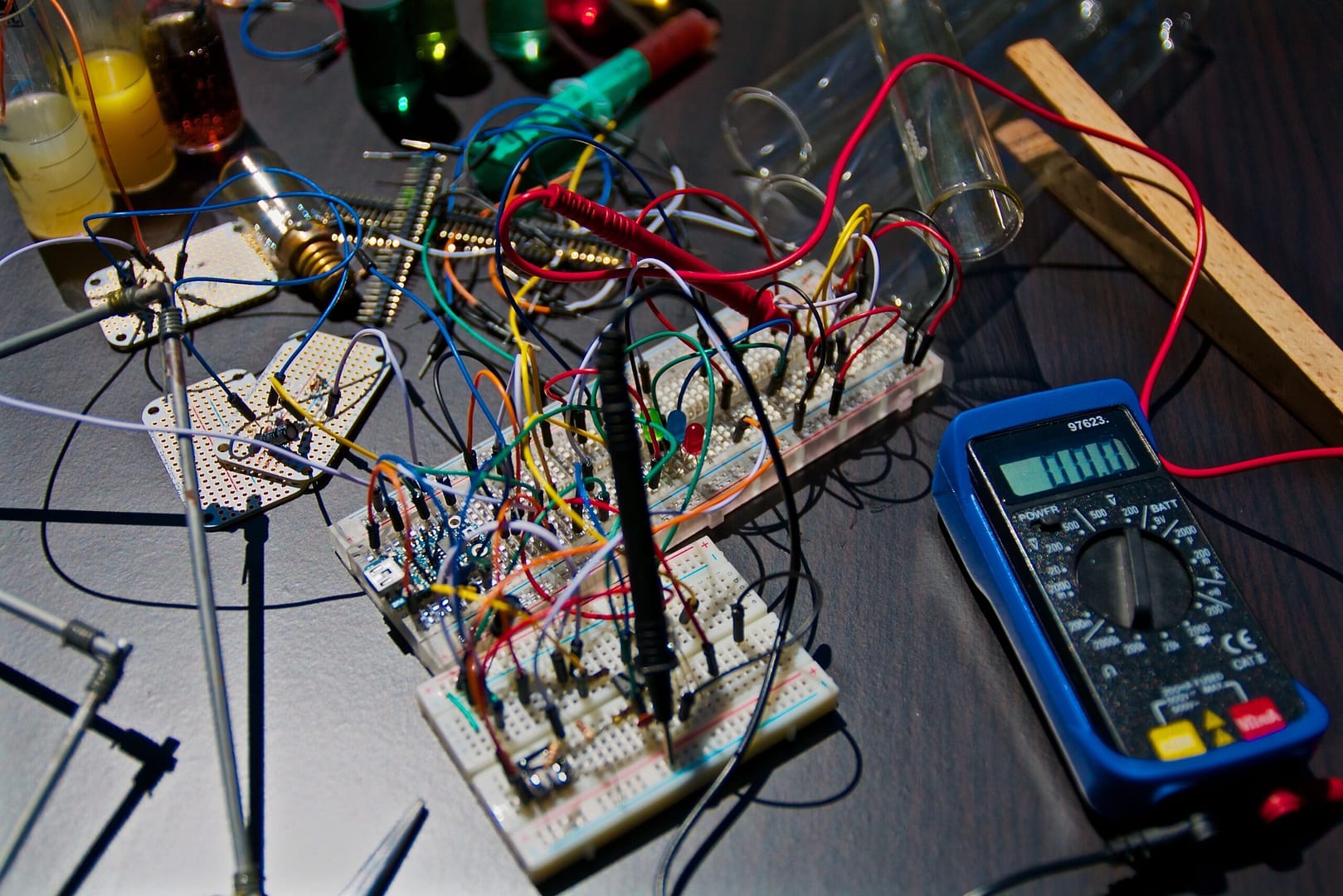 A table is covered with electrical components including a testing meter, wire, and circuit boards. Electrical contractors have many specialties ranging from residential electrician, commercial contractors, and master electricians who work on large scale industrial projects. Help your customers find the perfect electrician for the job on LocalSplash.