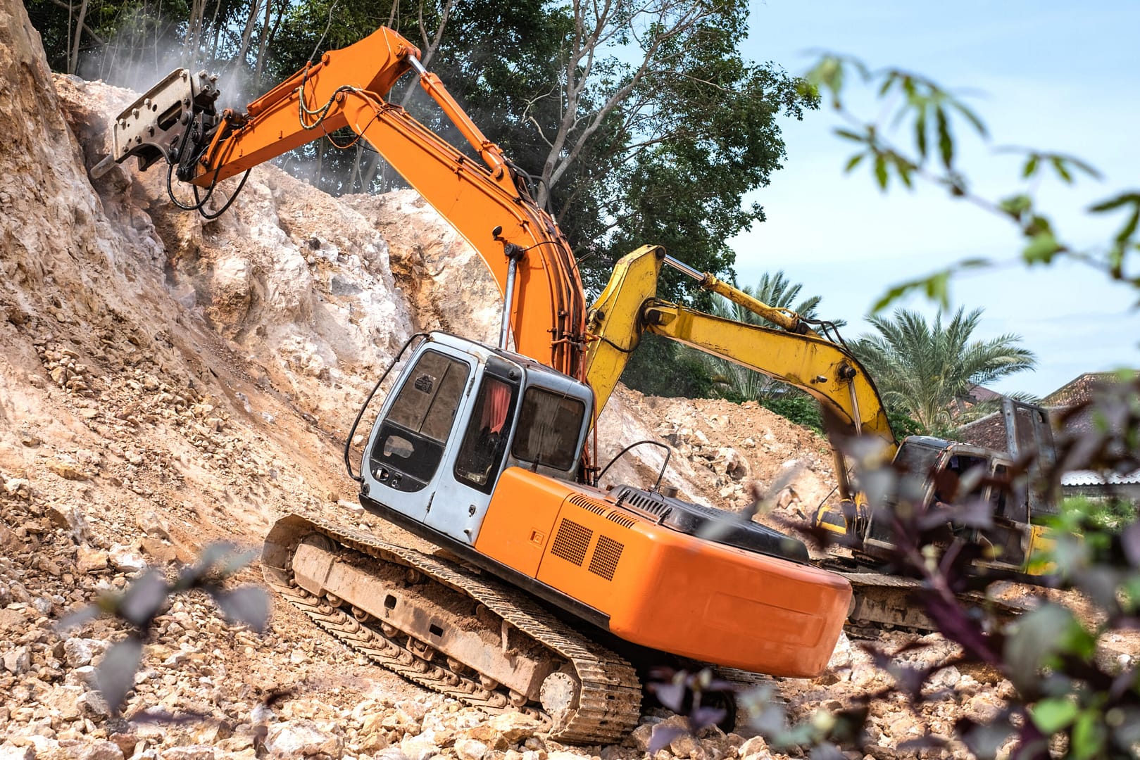 Powerful hydraulic jackhammer in action, breaking rocks into smaller pieces with precision and force.