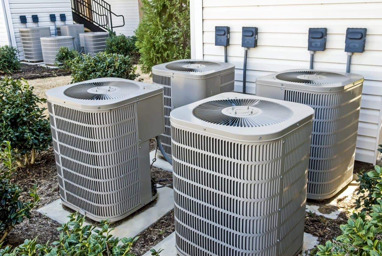 A group of air conditioning units outside a house