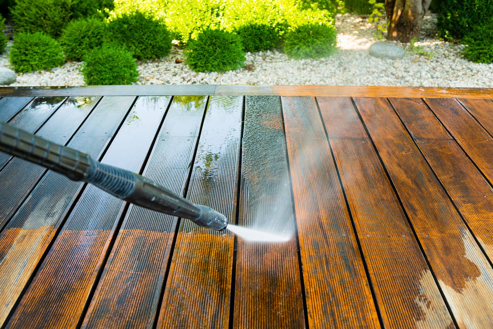 Before-and-after comparison of a deck being pressure washed, demonstrating the quality workmanship our marketing strategies represent.