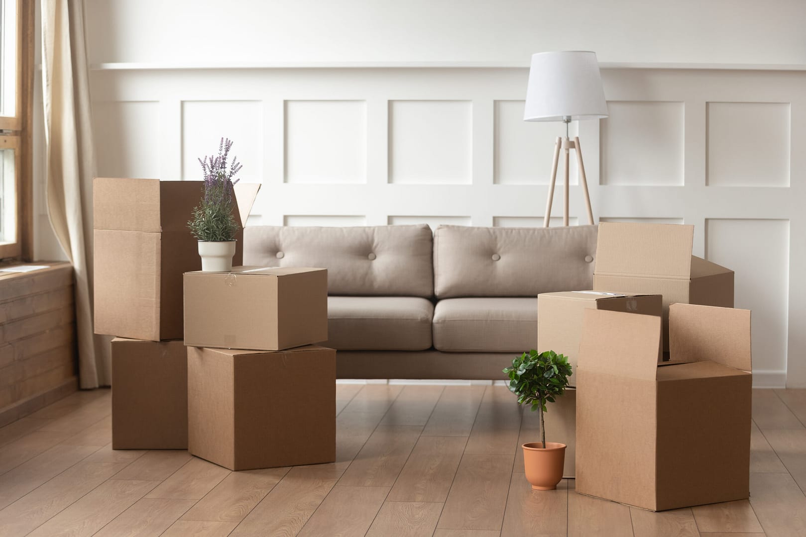 Residential moving day scene with furniture and boxes – Emphasizing the personal touch and care taken by moving companies during home relocations.