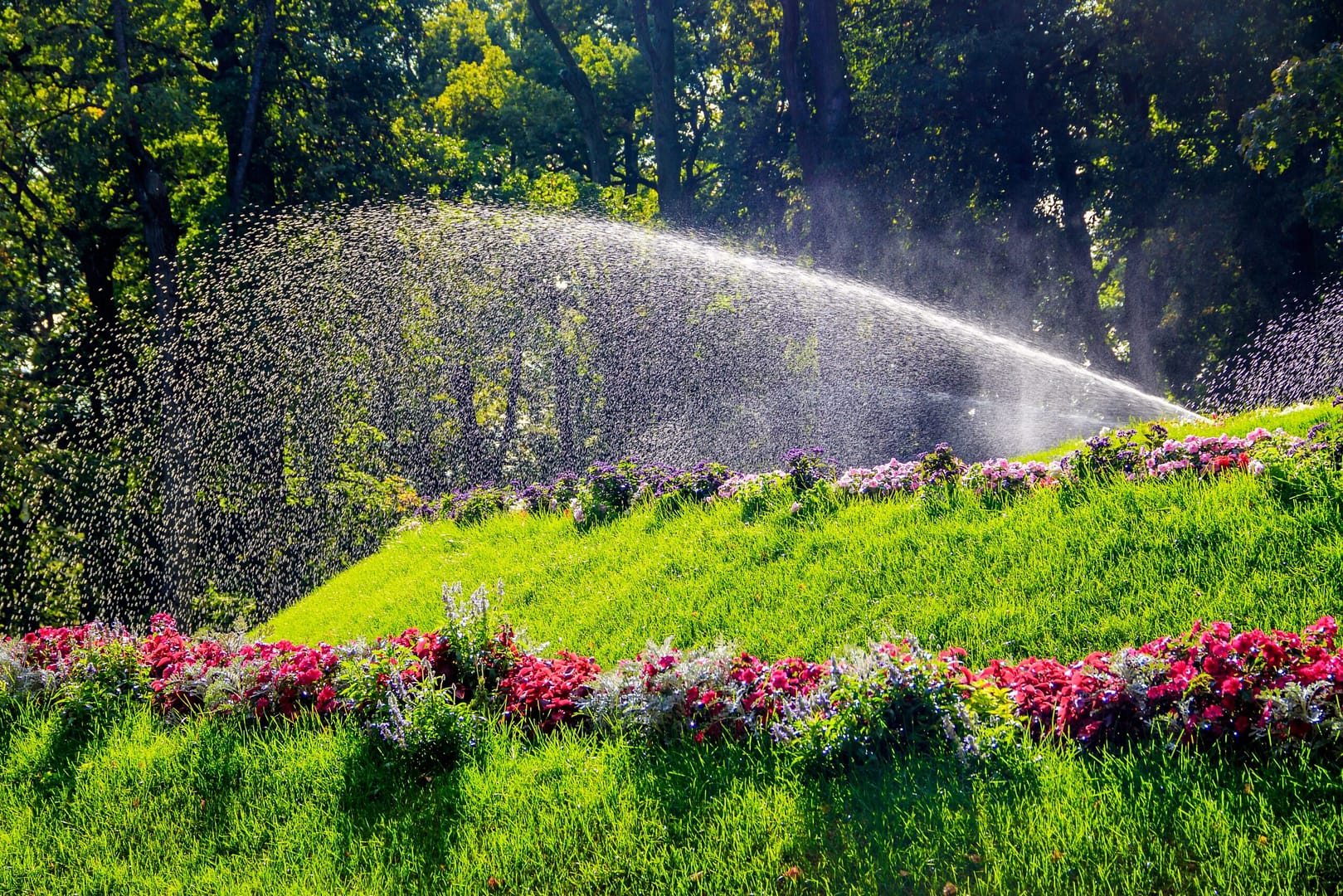 Sprinkler nurtures a verdant expanse of greenery and vibrant flowers – mirroring the continuous and targeted nourishment digital marketing provides to landscapers businesses.