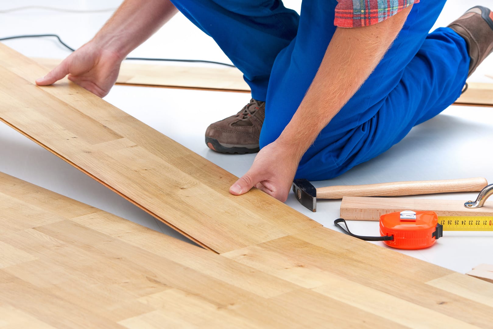 An installer works with hardwood flooring - Local Splash can help you showcase your expertise in using top-quality materials to create beautiful and long-lasting flooring solutions