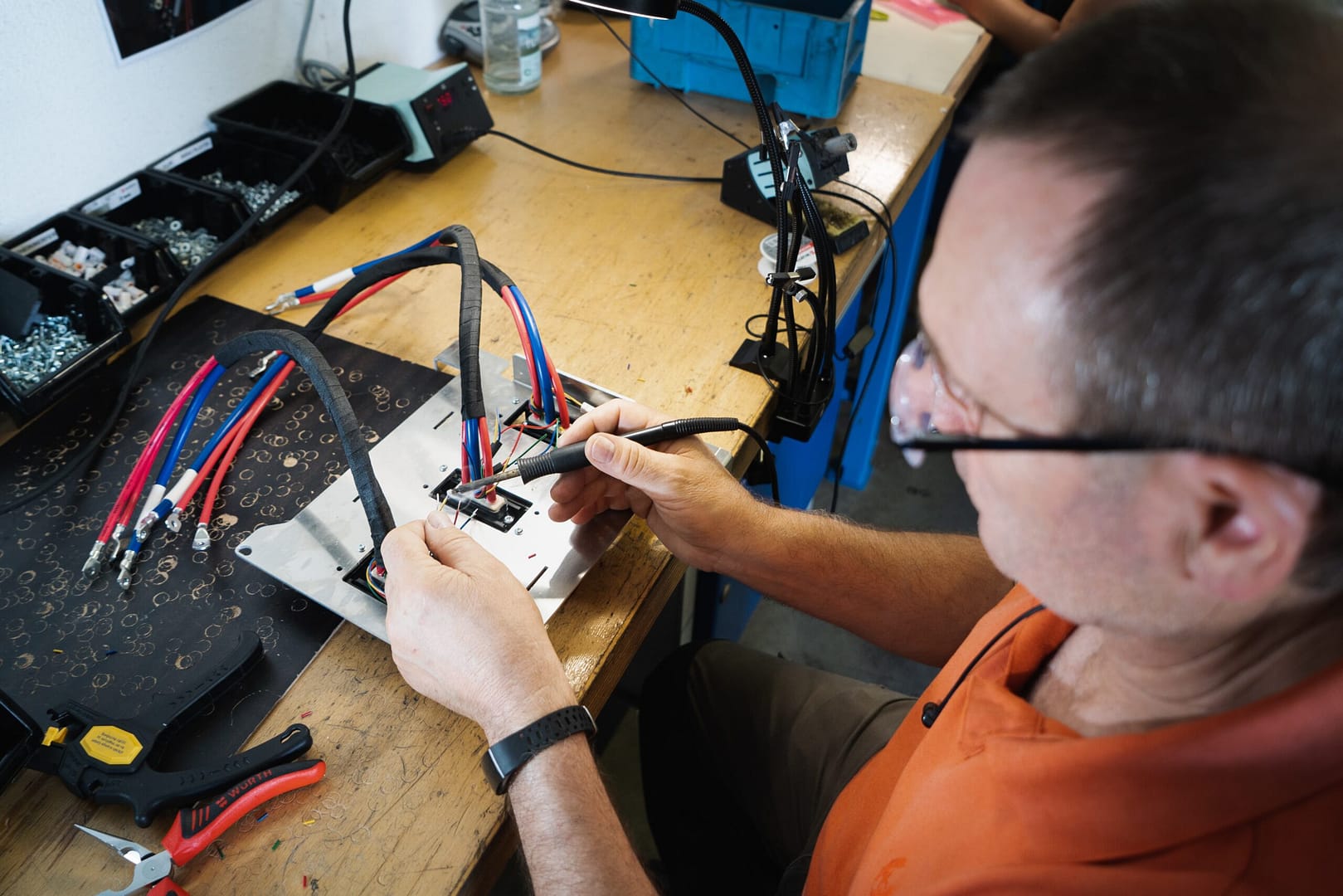An electrical technician places wires in a board. More electricians every day are converting leads from LocalSplash because it represents a good investment with strong ROI in their electrician business.