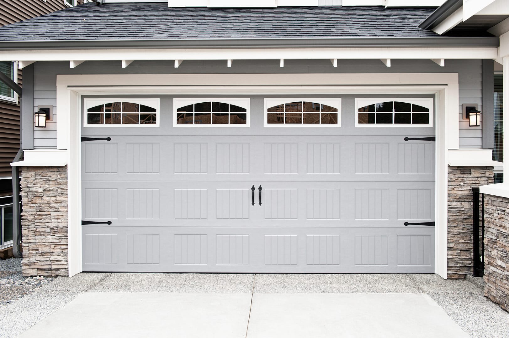 Exterior view of a garage door showing a perfect installation on a suburban home. Enhance your online presence with local splash's expert digital strategies for garage door installers.