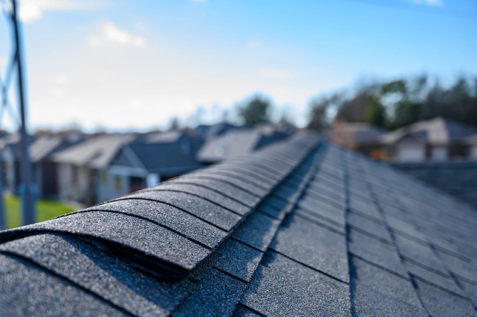 Roof covered in asphalt shingles with a neatly installed ridge cap for added durability and protection.
