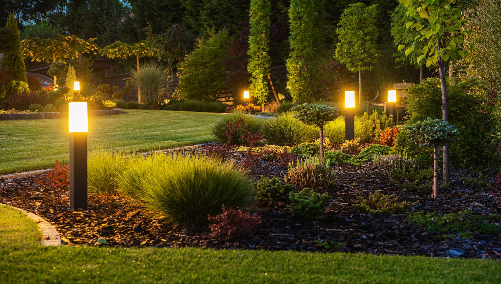 Vibrant outdoor LED lighting illuminating a contemporary backyard space, creating a warm and inviting atmosphere for relaxation and gatherings.